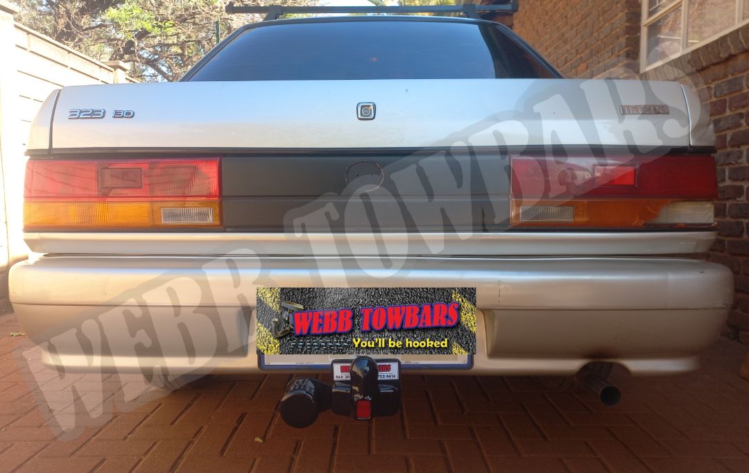 Mazda 323 Sedan fitted with a standard towbar by Webb Towbars in Gauteng, South Africa – custom-manufactured solution for reliable towing performance